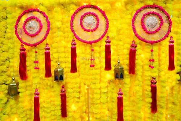 A rectangular stand draped with yellow garlands forms a backdrop for your celebrations.