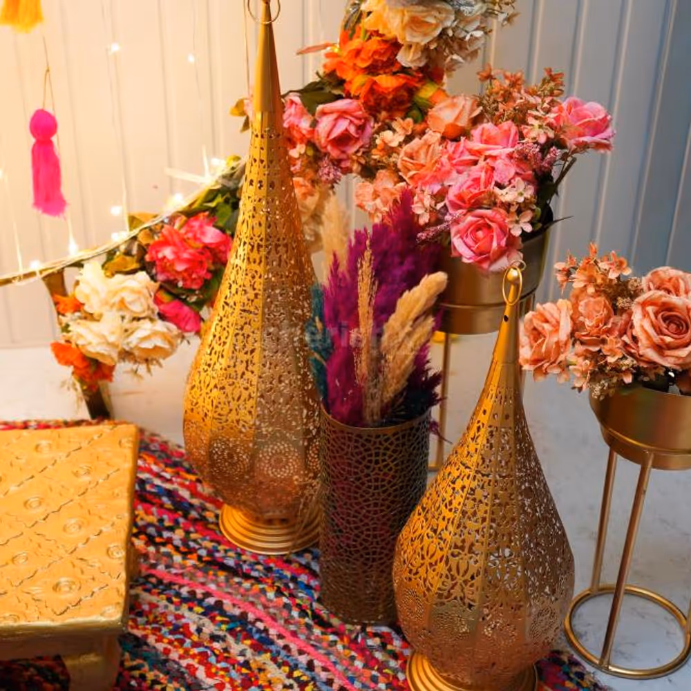 Infuse your celebrations with a touch of grandeur and golden flower pots brimming with artificial flower bunches, and more