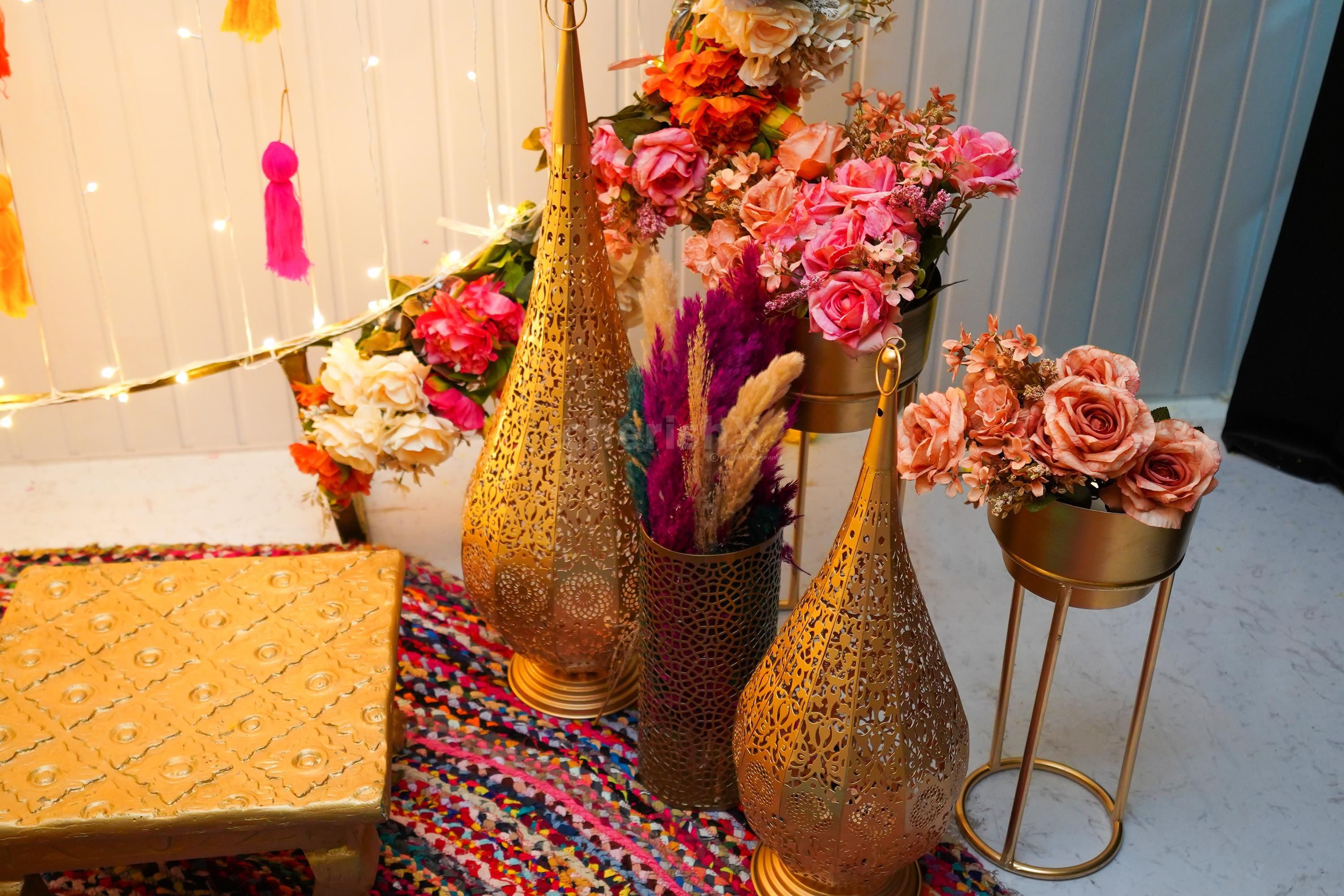 Infuse your celebrations with a touch of grandeur and golden flower pots brimming with artificial flower bunches, and more