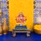 Immerse in the serenity of a blue Textured Flex adorned with artificial yellow garlands, as our decoration sets the space for a spiritually charged celebration.