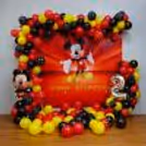 Step into a world filled with their favourite cartoon character, Mickey Mouse, surrounded by a backdrop of colourful balloons and whimsical decor.