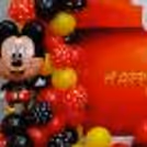 The party setup includes a stunning backdrop flex that sets the stage for memorable photos and cherished moments.