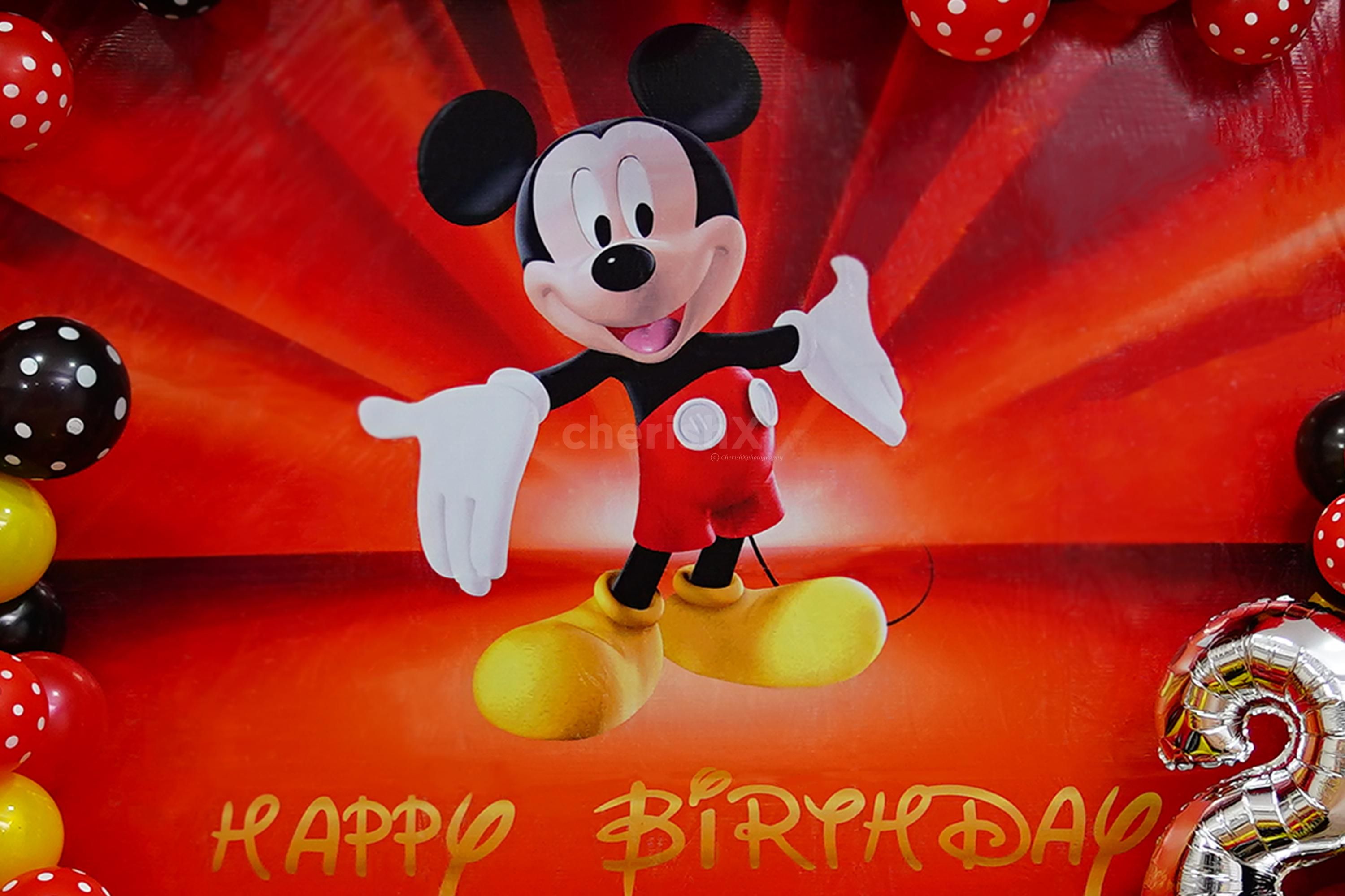 With a vibrant arch of red latex, yellow latex, black metallic, and polka dot black & red balloons, the ambience is filled with joy and playfulness.
