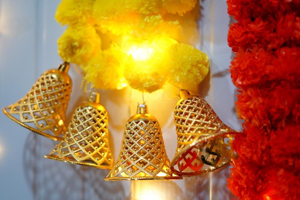 Vibrant yellow and orange marigold garlands with LED lights.