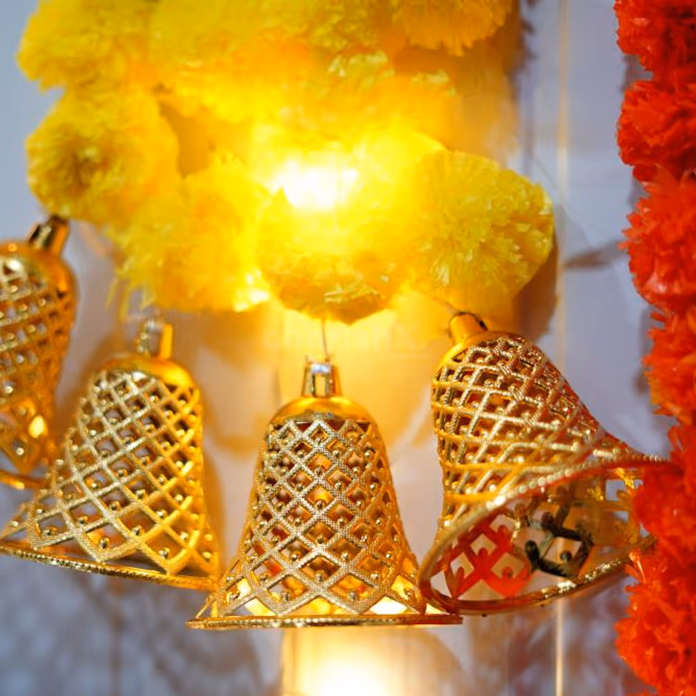 Vibrant yellow and orange marigold garlands with LED lights.