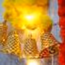 Vibrant yellow and orange marigold garlands with LED lights.