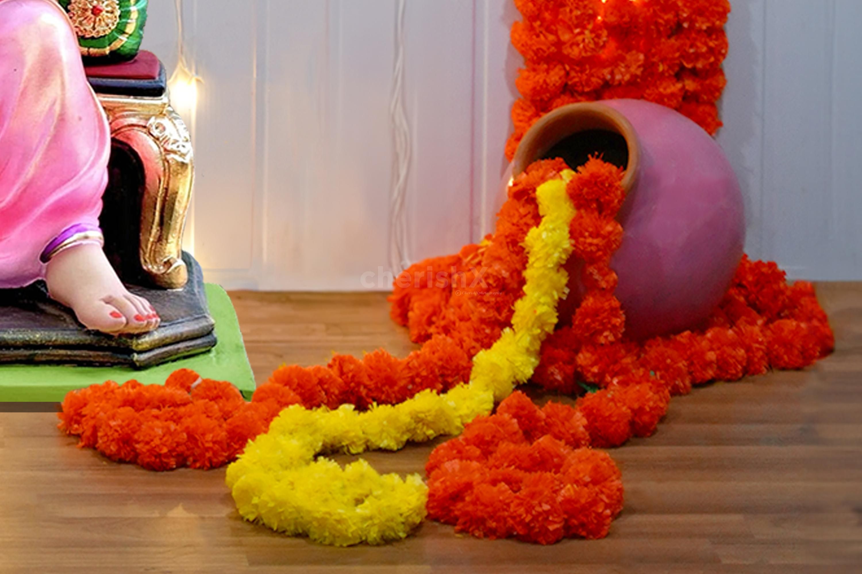 Adorned with Golden bells and earthy mud pots enhance the decor.