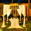 Romantic cabana decor enchants you with soft white drapes, twinkling fairy lights, fragrant blooms, and the warm glow of candles.