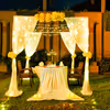 Romantic cabana decor enchants you with soft white drapes, twinkling fairy lights, fragrant blooms, and the warm glow of candles.
