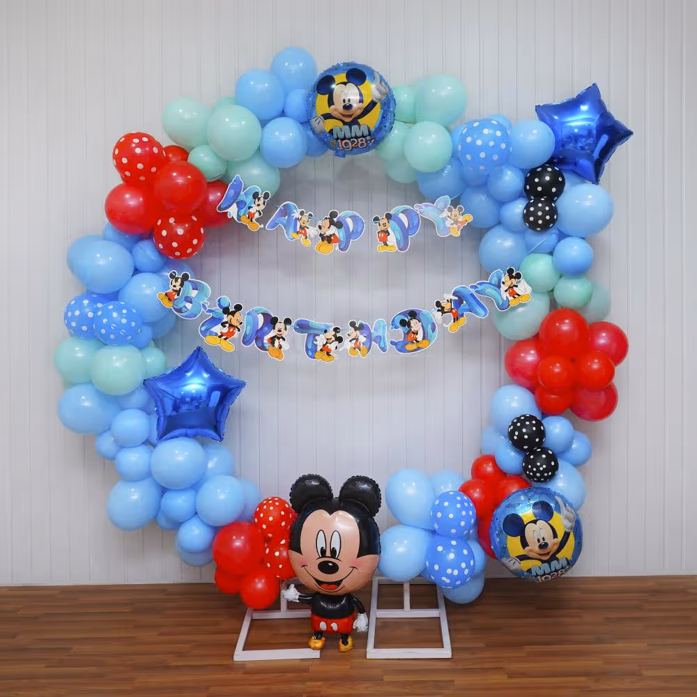 From the iconic Happy Birthday Mickey bunting to the enchanting mix of balloons in pastel blue, green, and red, every detail celebrates the timeless charm of Disney.