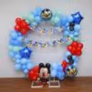 From the iconic Happy Birthday Mickey bunting to the enchanting mix of balloons in pastel blue, green, and red, every detail celebrates the timeless charm of Disney.