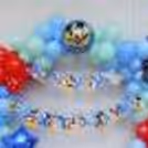 Our Sparkling Blue Balloon Decoration sets the stage with a burst of color that includes soothing blue, fresh green, and vibrant red balloons.