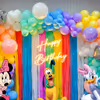 Elevate the Celebration with Vibrant Balloon Arches and Playful Frill Curtains.