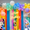 Elevate the Celebration with Vibrant Balloon Arches and Playful Frill Curtains.