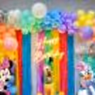 Elevate the Celebration with Vibrant Balloon Arches and Playful Frill Curtains.