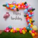 Step into a Flamingo Balloon Bliss Decoration, Where Vibrant Balloons and Palm Leaves Set the Scene.