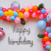 Elevate the Celebration with a Balloon Arch Bursting with Yellow, Blue, and Magenta Hues.