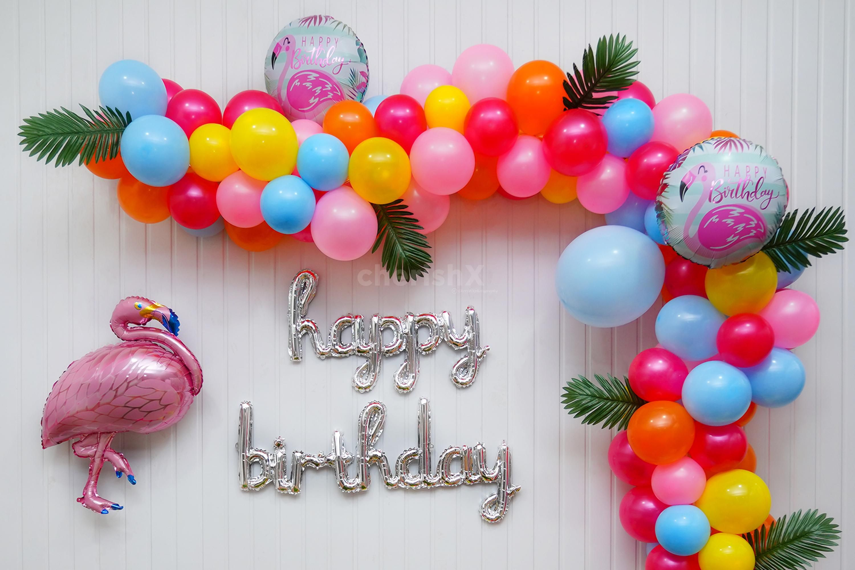 Elevate the Celebration with a Balloon Arch Bursting with Yellow, Blue, and Magenta Hues.