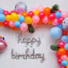 Elevate the Celebration with a Balloon Arch Bursting with Yellow, Blue, and Magenta Hues.