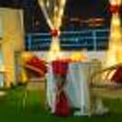 A dreamy haven under the sky! Picture yourself amidst white curtains, vibrant flowers, and a backdrop for an unforgettable dining experience.