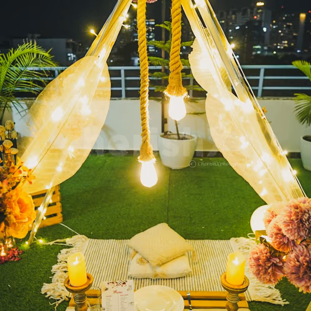 Low dining tables, wooden candle stands, and cosy mats with cushions set the perfect scene for a romantic evening.