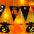 Embrace Halloween with Pumpkin Bunting and Ghost Paper Cutouts.