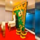 Delicate marigold flowers adorn a Coconut leaf stand backdrop, creating a tranquil ambience for a baby shower celebration.