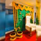 Delicate marigold flowers adorn a Coconut leaf stand backdrop, creating a tranquil ambience for a baby shower celebration.
