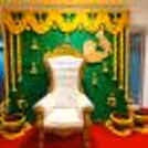 Delicate marigold flowers adorn a Coconut leaf stand backdrop, creating a tranquil ambience for a baby shower celebration.