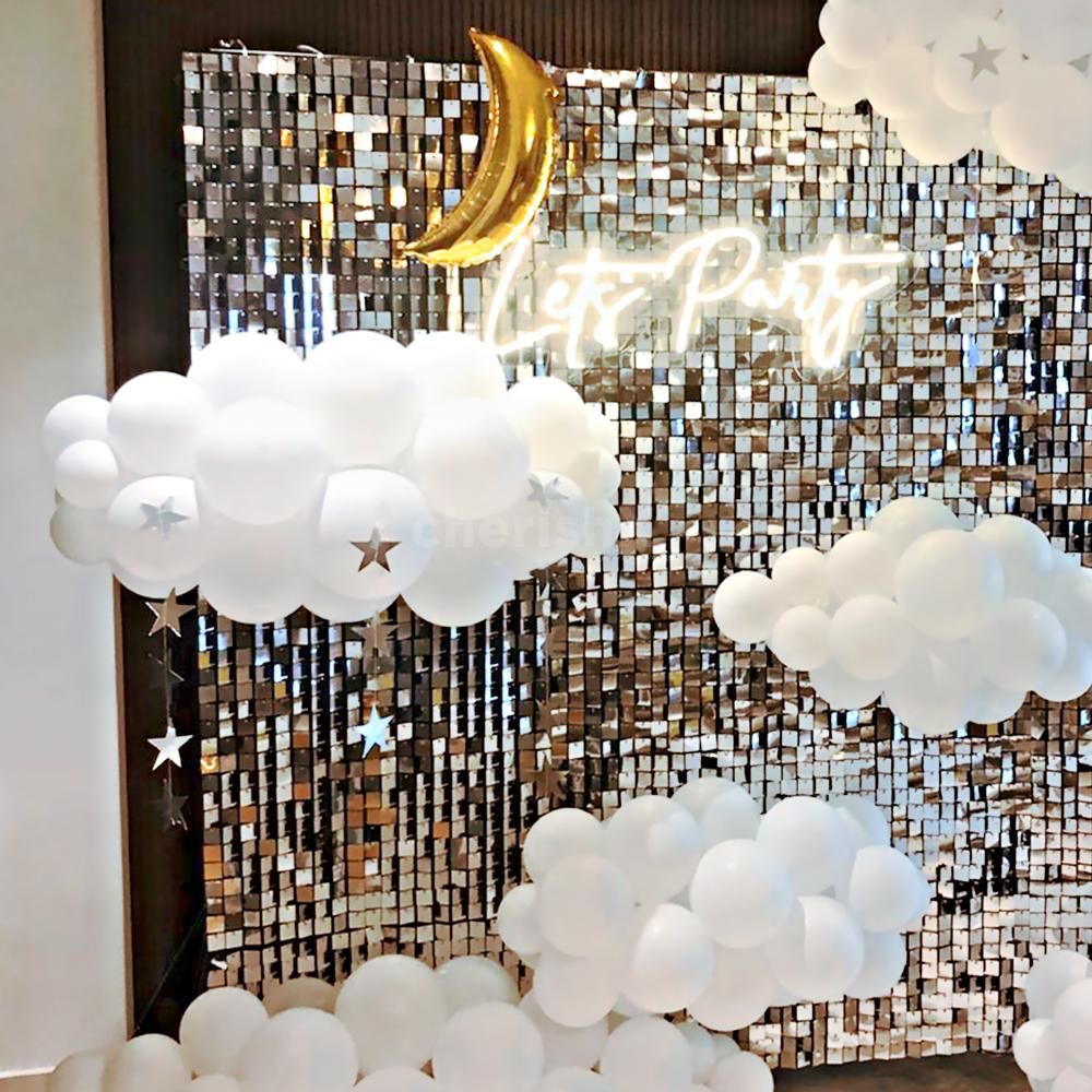 Our decor transforms your space into a tranquil oasis, adorned with silver stars, golden moons, and clouds of white latex balloons.