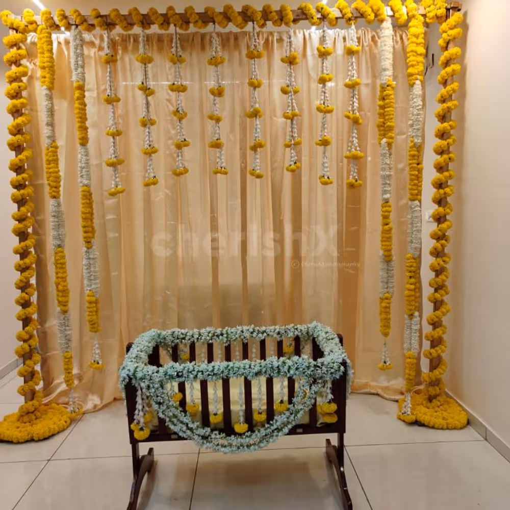 A gold-coloured backdrop adorned with 11 rows of marigold yellow and lily flowers, creates a captivating and visually striking centrepiece.