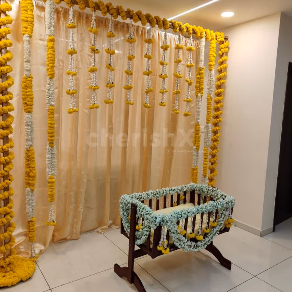 A gold-coloured backdrop adorned with 11 rows of marigold yellow and lily flowers, creates a captivating and visually striking centrepiece.