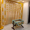 A gold-coloured backdrop adorned with 11 rows of marigold yellow and lily flowers, creates a captivating and visually striking centrepiece.