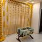 A gold-coloured backdrop adorned with 11 rows of marigold yellow and lily flowers, creates a captivating and visually striking centrepiece.