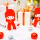 A Christmas tree also showcases beautifully arranged decorations, such as red Santa socks, and red deer ornaments.