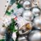 A perfect centerpiece for Christmas celebration adorned with silver 3D snowflakes, and silver balls.