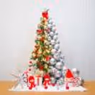 A 6-ft Non-Pine Christmas tree adorned with Silver Chrome Balloons.