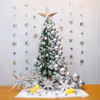 A beautiful Christmas tree decoration features a 6-ft non-pine tree decked out with silver chrome balloons, LED lights, and a silver paper star.