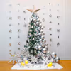 A beautiful Christmas tree decoration features a 6-ft non-pine tree decked out with silver chrome balloons, LED lights, and a silver paper star.