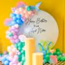 A whimsical birthday setup featuring a ring backdrop.