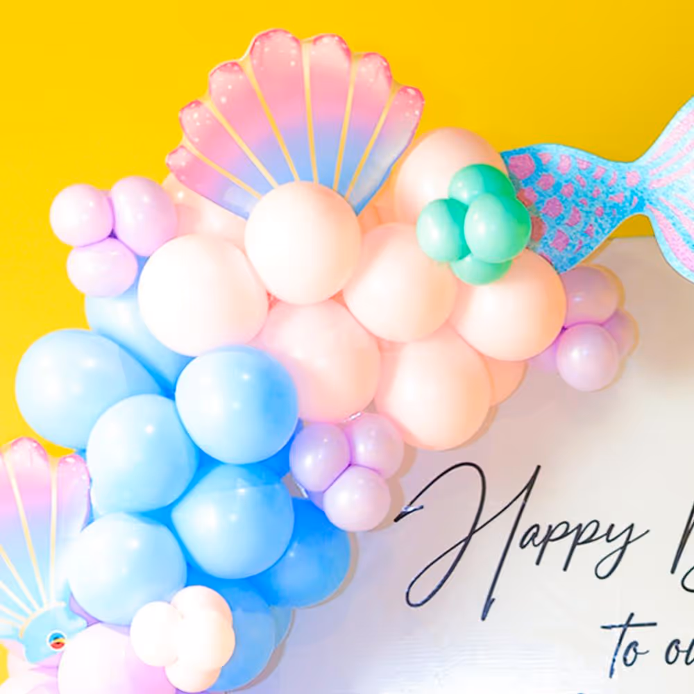 A magical backdrop comes with cake tables and enchanting sunboard cutouts.