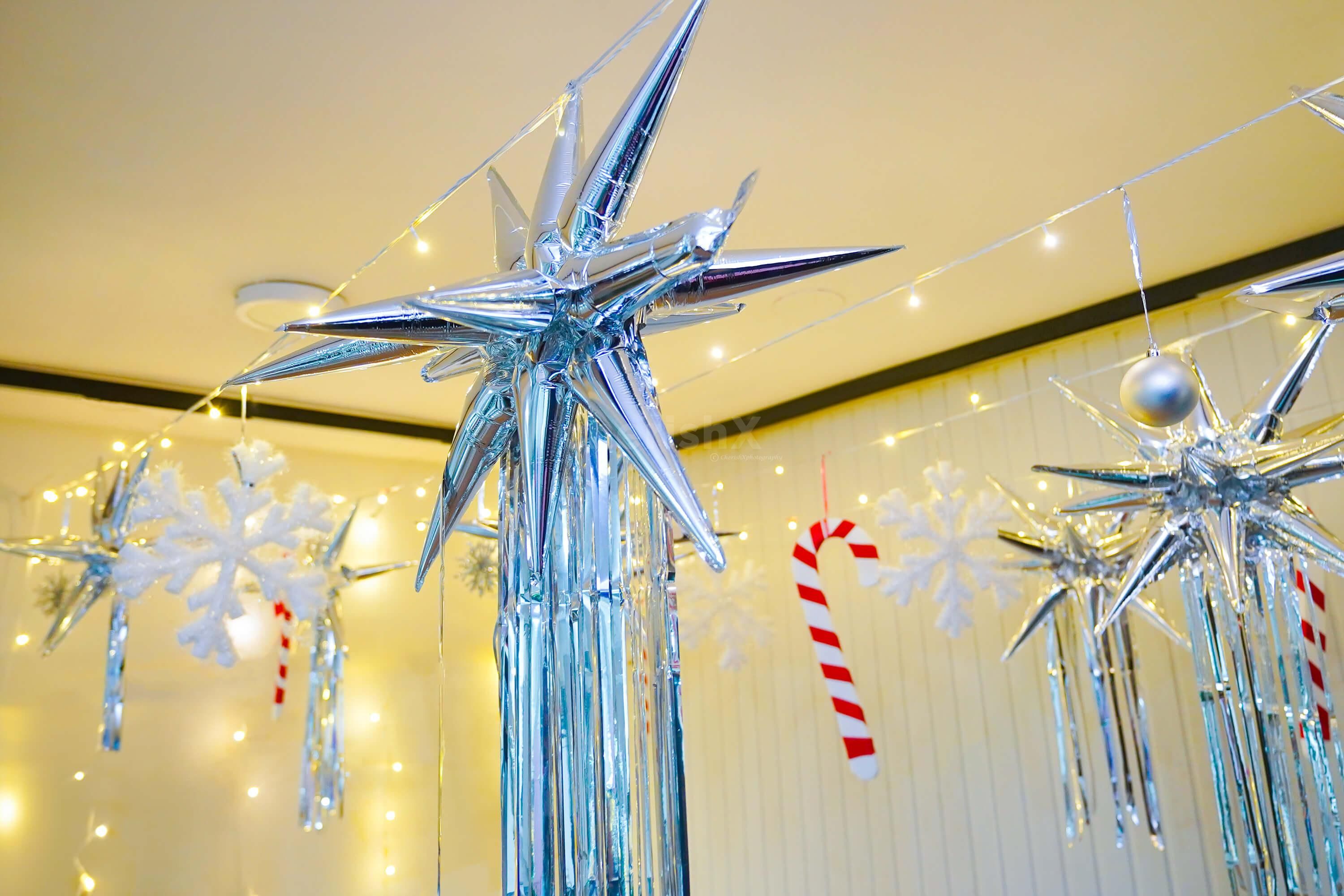Captivating ensemble featuring silver Star Foil Balloons, a Silver Frill Curtain, and Pixel Lights.