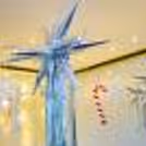 Captivating ensemble featuring silver Star Foil Balloons, a Silver Frill Curtain, and Pixel Lights.