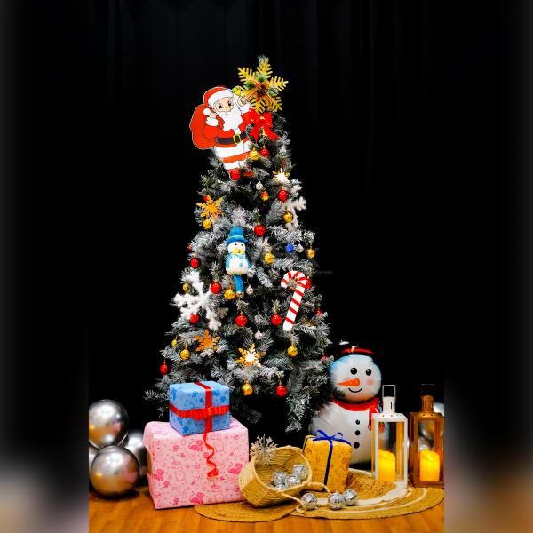 A radiant 6 Ft white European Christmas tree adorned with golden snowflakes and bow entrance hangings.