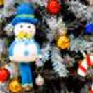 Golden snow cutouts, mirror balls, and a mix of festive decorations create a glittering display near the tree.
