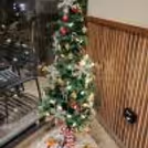 A 6-ft tree surrounded by delightful ornaments, candy sticks, and gift boxes.