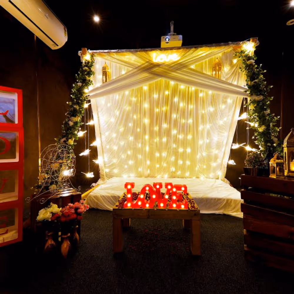 Step into a dreamy cabana adorned with drapes and soft lights for an enchanting movie night experience.