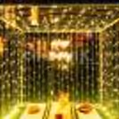Wooden crates decorated with floor lamps, jute mats, and vases filled with artificial flowers, create a whimsical atmosphere in the cabana.
