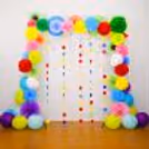 Rosettes, pom-poms, round decor, and lanterns create a vibrant Diwali festivity backdrop.