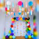 A close-up of vibrant honeycomb balls in various hues, part of festive decorations.